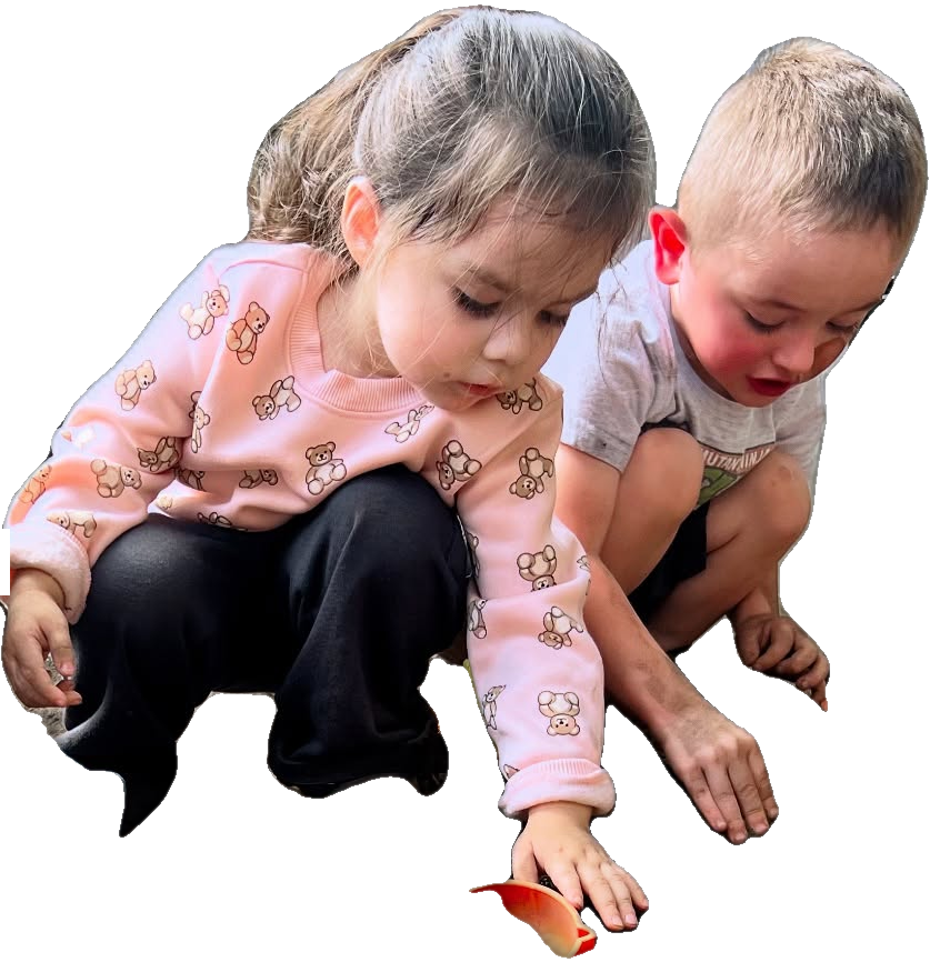 Children playing and exploring outdoors at Rita's Kids Daycare